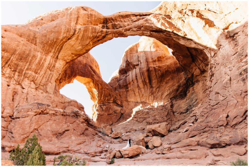 Bride and groom at the bottom of Double Arch after their elopement ceremony.