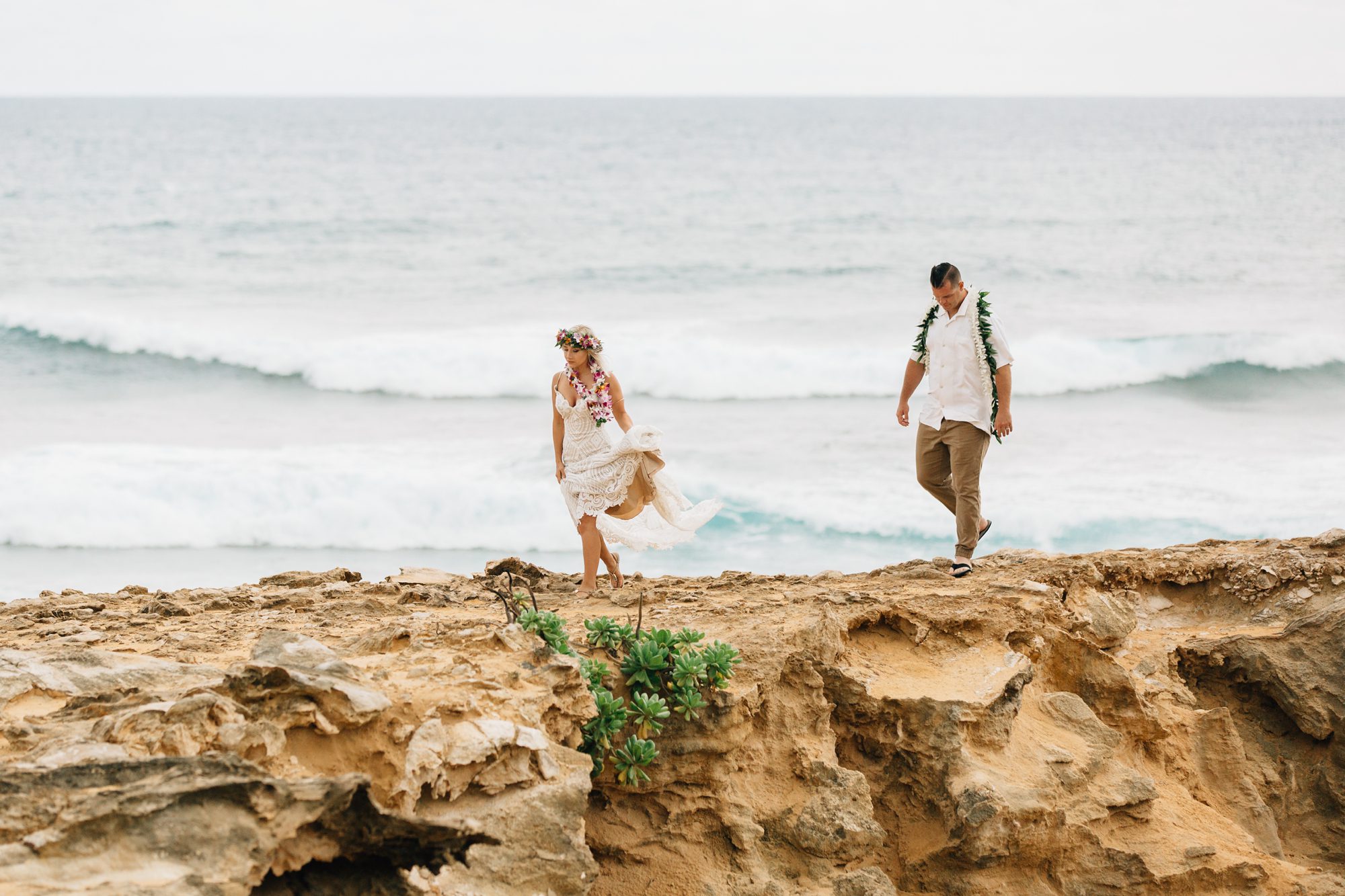 Bride and groom take a small hike during their adventurous Kauai elopement.